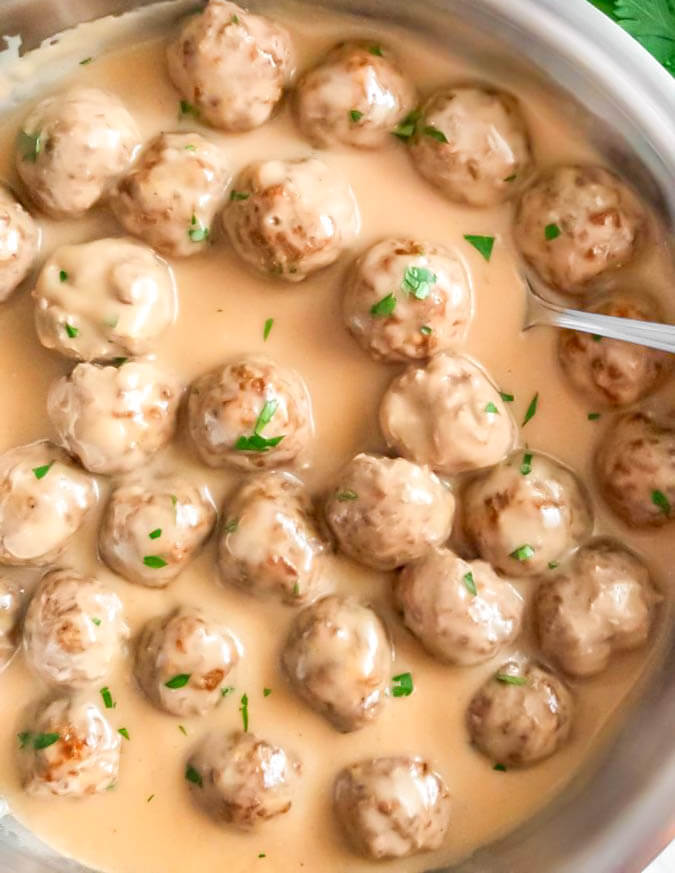 Baked Swedish Meatballs with Gravy sprinkled with fresh parsley