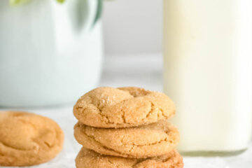 Stack of Chewy Ginger Molasses Cookies with a glass of milk