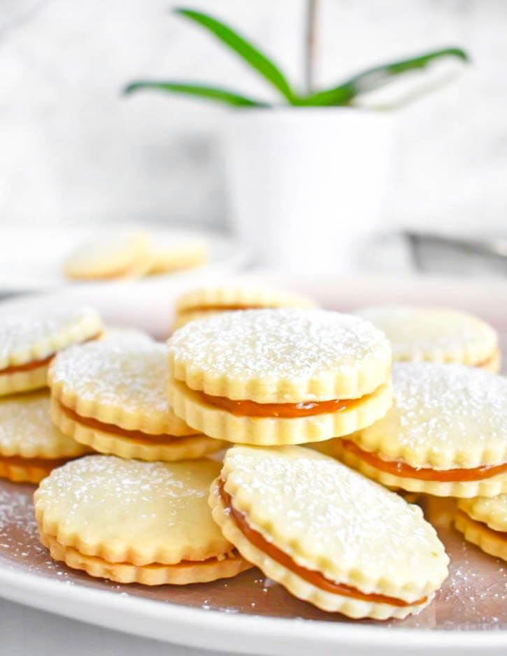 Dulce de Leche Sandwich Cookies (Alfajores) sprinkled with powdered sugar