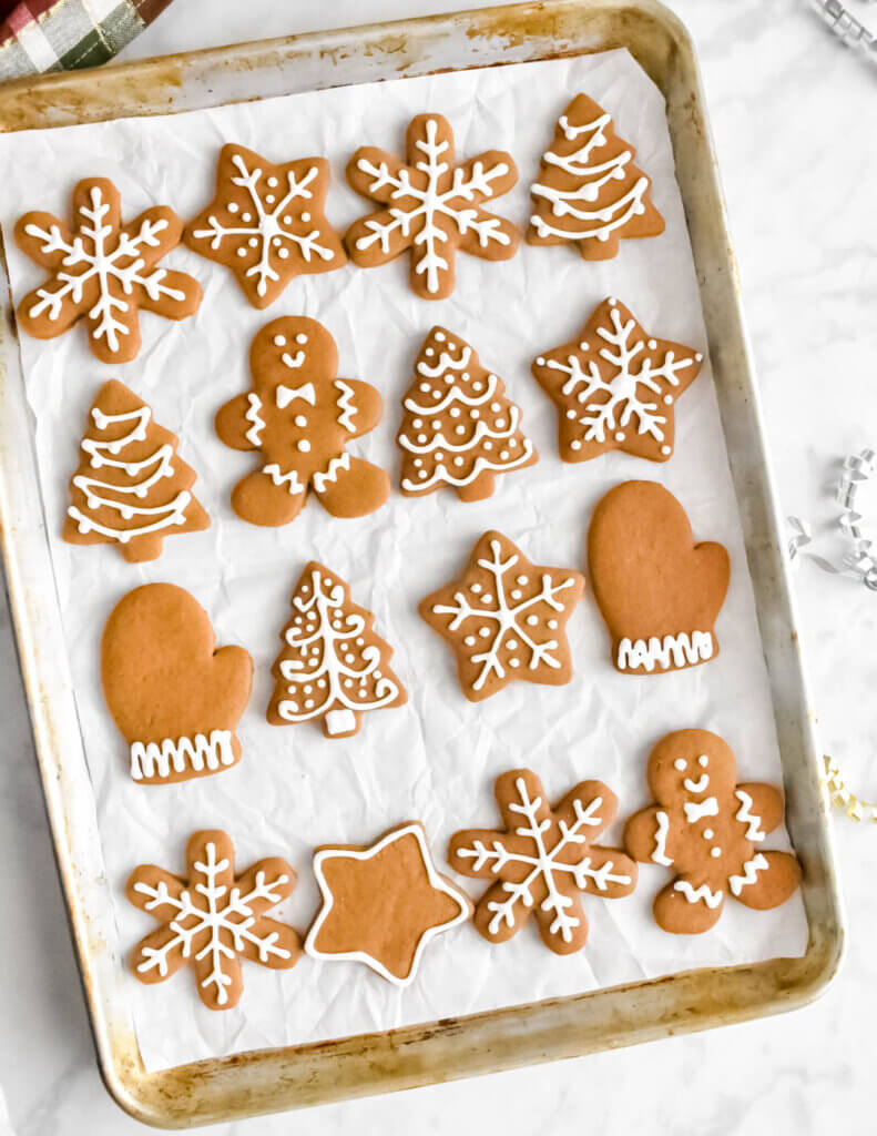 Top view of a tray of gingerbread cookies decorated with icing