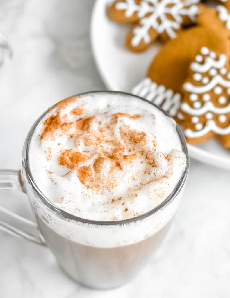 Gingerbread latte with a plate of gingerbread cookies