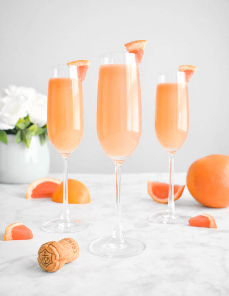 grapefruit mimosa cocktails in champagne flutes