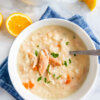 Bowl of Greek Lemon Chicken Soup (Avgolemono Soup) topped with chicken and fresh parsley