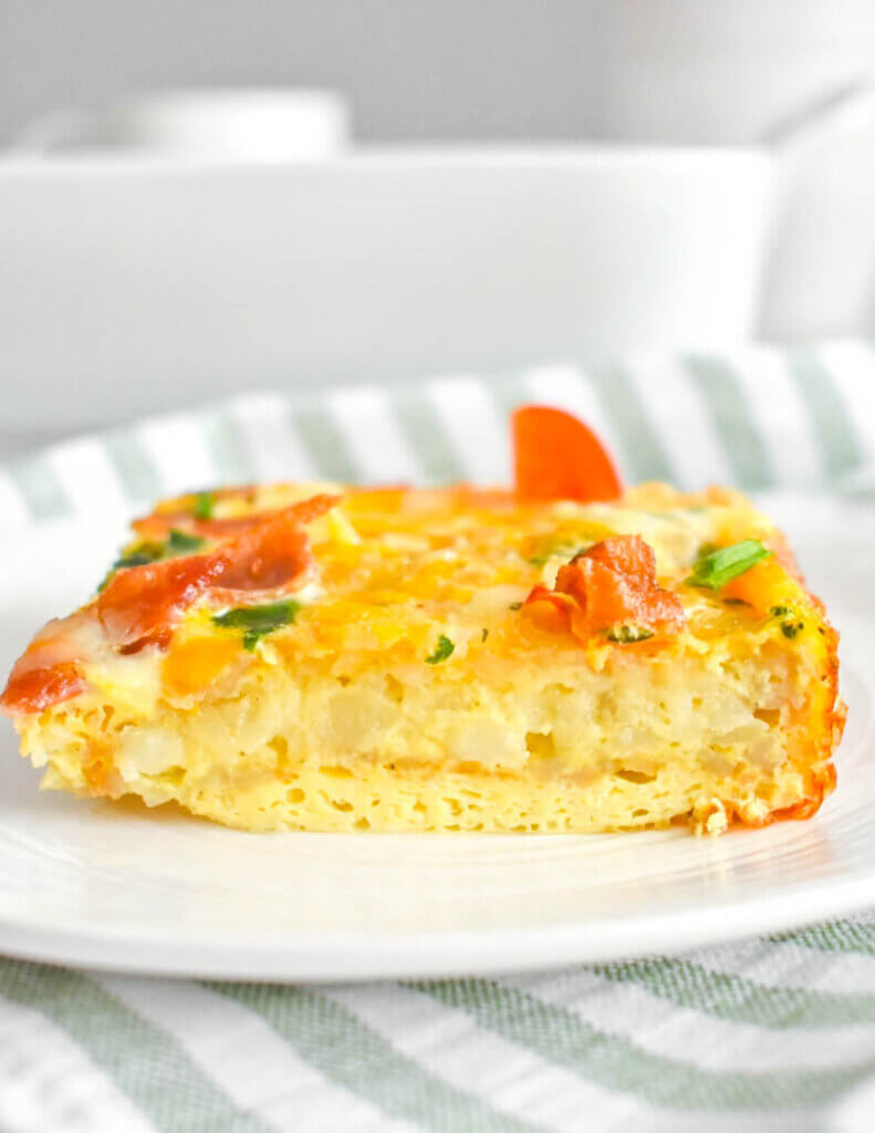 Side view of a slice of Hashbrown Breakfast Casserole on a plate