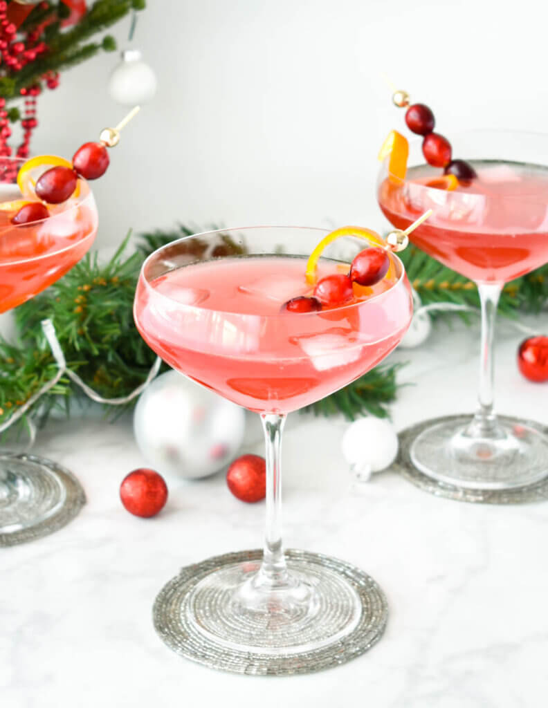 close up of Holiday cocktails garnished with fresh cranberries