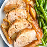 Plate of sliced Pork Tenderloin with carmelized apples, onions and green beans.