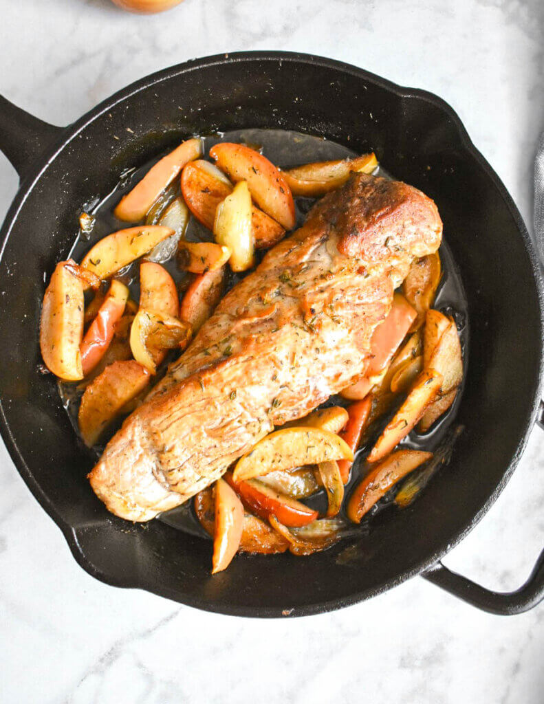 Skillet with pork tenderloin, carmelized apples and onions.