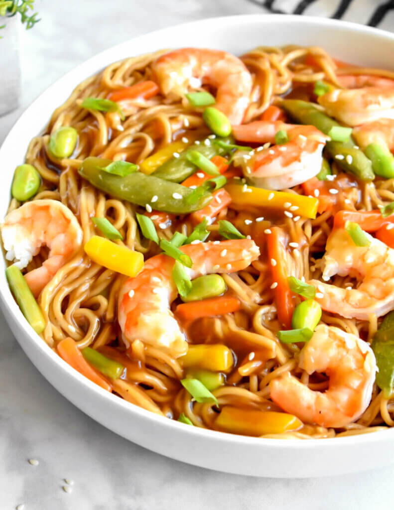 Bowl of ramen noodles with lots of shrimp and veggies