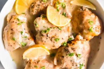 Slow Cooker Creamy Lemon Chicken Thighs with lemon wedges