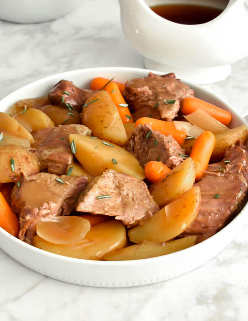Roast beef, potatoes, carrots and onions with gravy