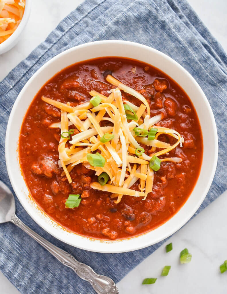 Bowl of Slow Cooker Turkey Chili topped with shredded cheese