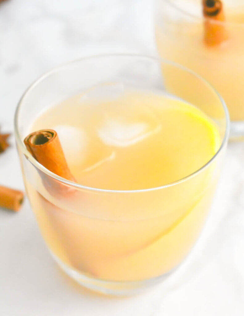 Closeup of a Spiced Pear Gin Fizz garnished with a cinnamon stick