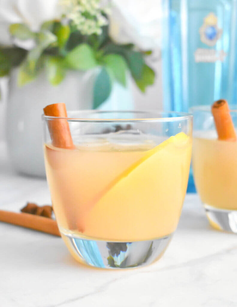 Spiced Pear Gin Fizz with a bottle of gin