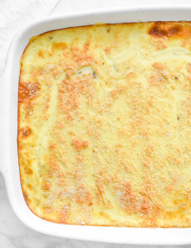 Closeup topview of a baked pastitsio with a golden crust.