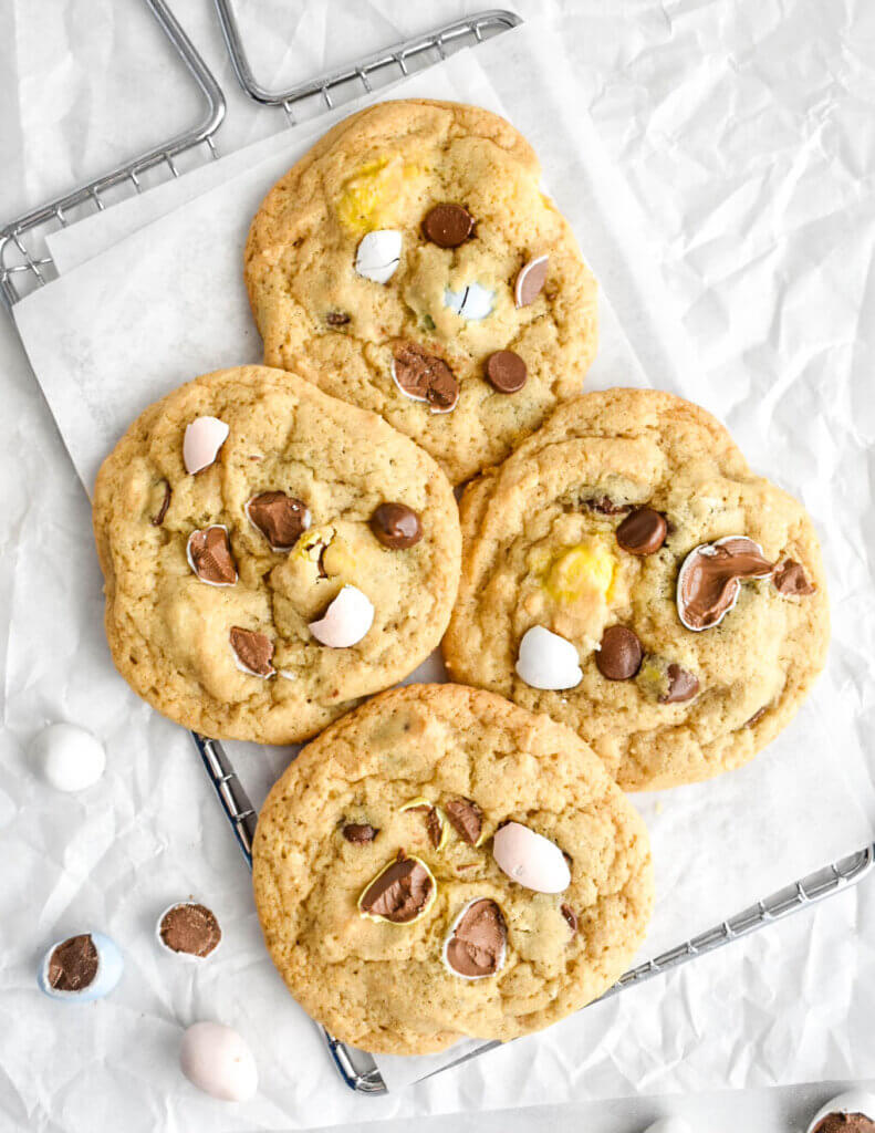 Four Easter Chocolate Chip Cookies set on a cooling rack under parchment paper.