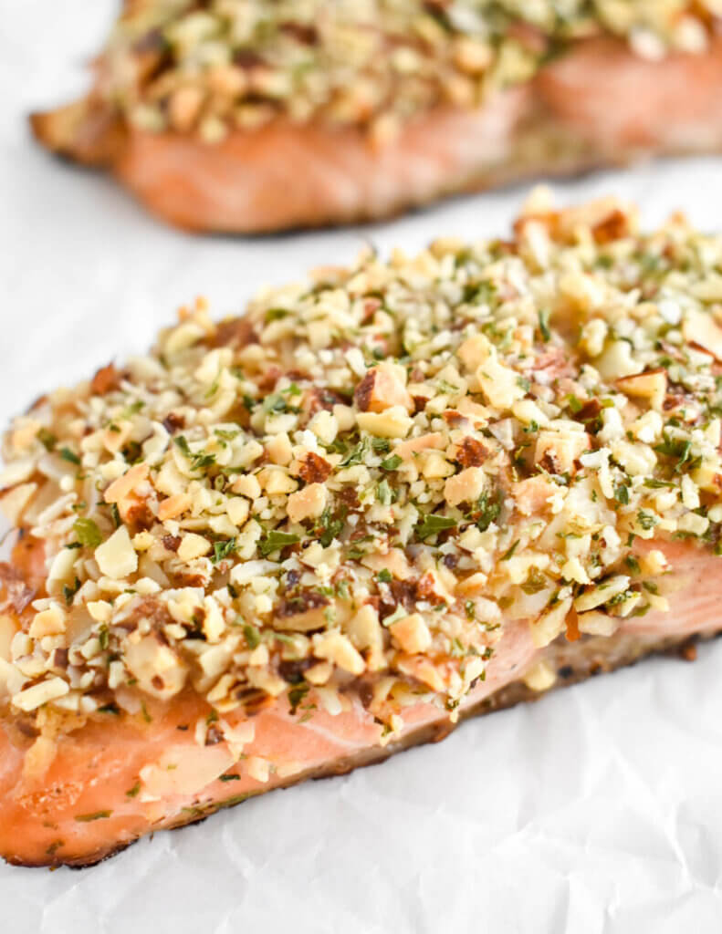 Closeup of the chopped almond and parsley crust on a salmon fillet.