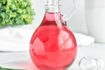 Chive Blossom Vinegar in a clear bottle.