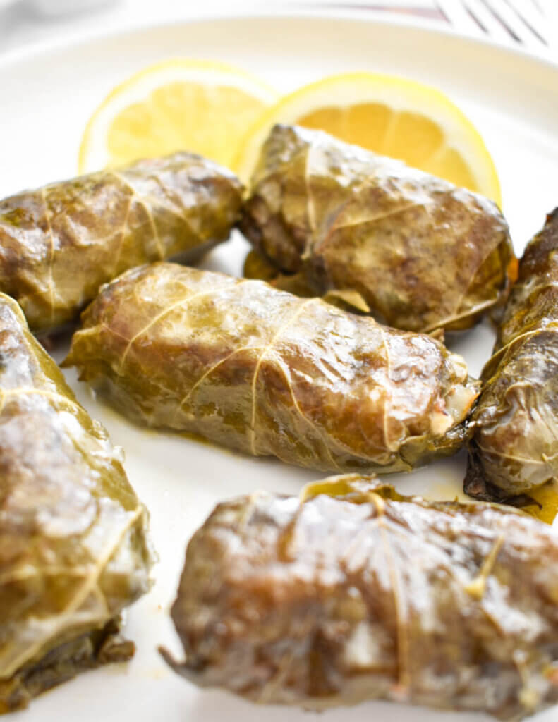 Closeup of dolmades on a plate.