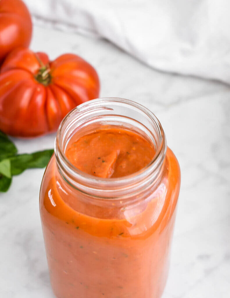 Closeup of a jar of roasted tomato sauce.
