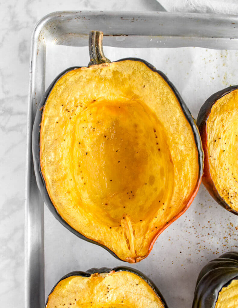 Close up of a halved and roasted acorn squash.