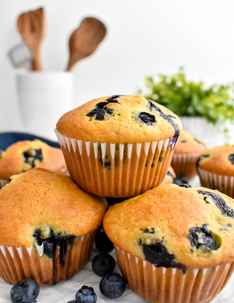 Closeup of a pile of Buttermilk Blueberry Muffins.
