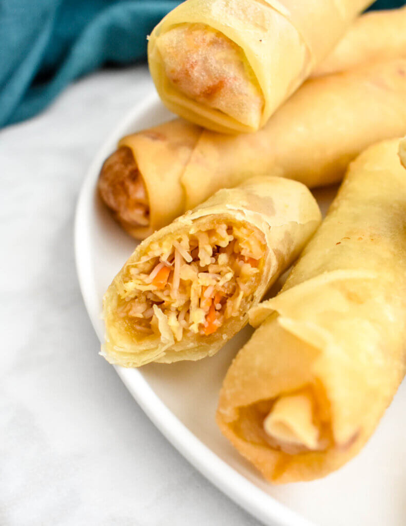 Closeup of a sliced spring roll showing the vegetable and vermicelli noodle filling.