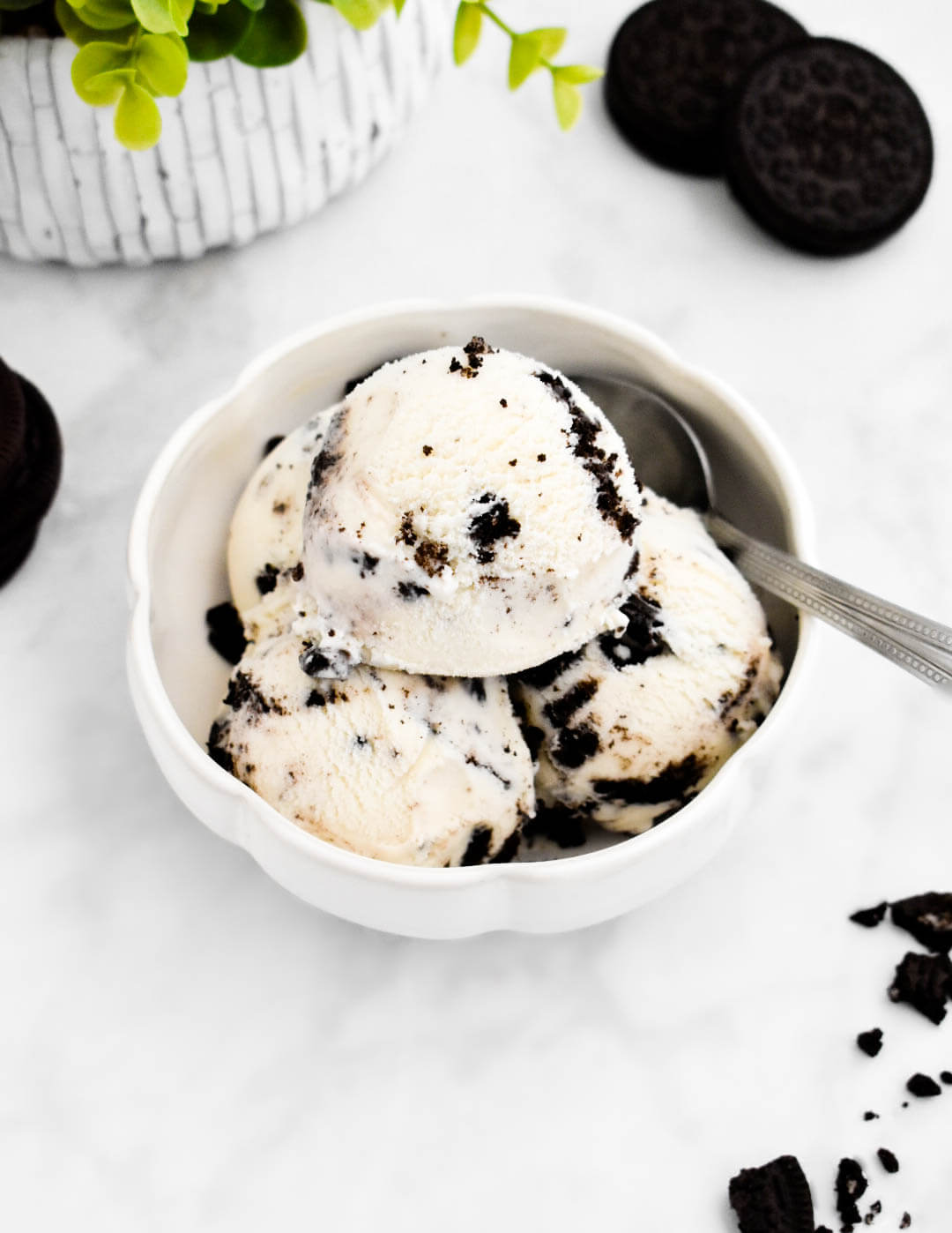 Closeup of scooped Oreo ice cream in a white bowl.