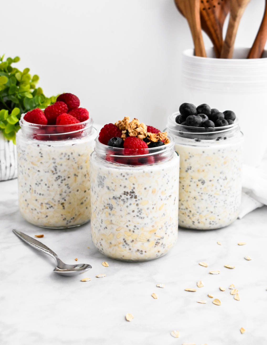 3 jars of overnight oats topped with berries and granola.