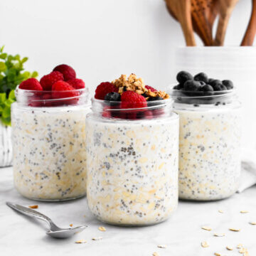 3 jars of overnight oats topped with berries and granola.