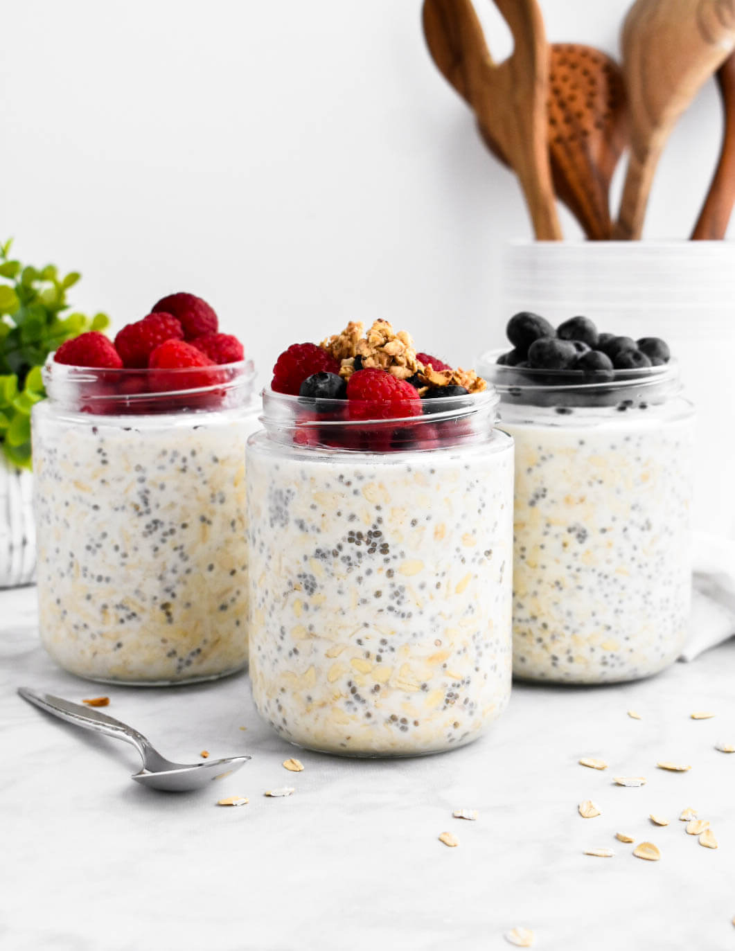 3 jars of overnight oats topped with berries and granola.