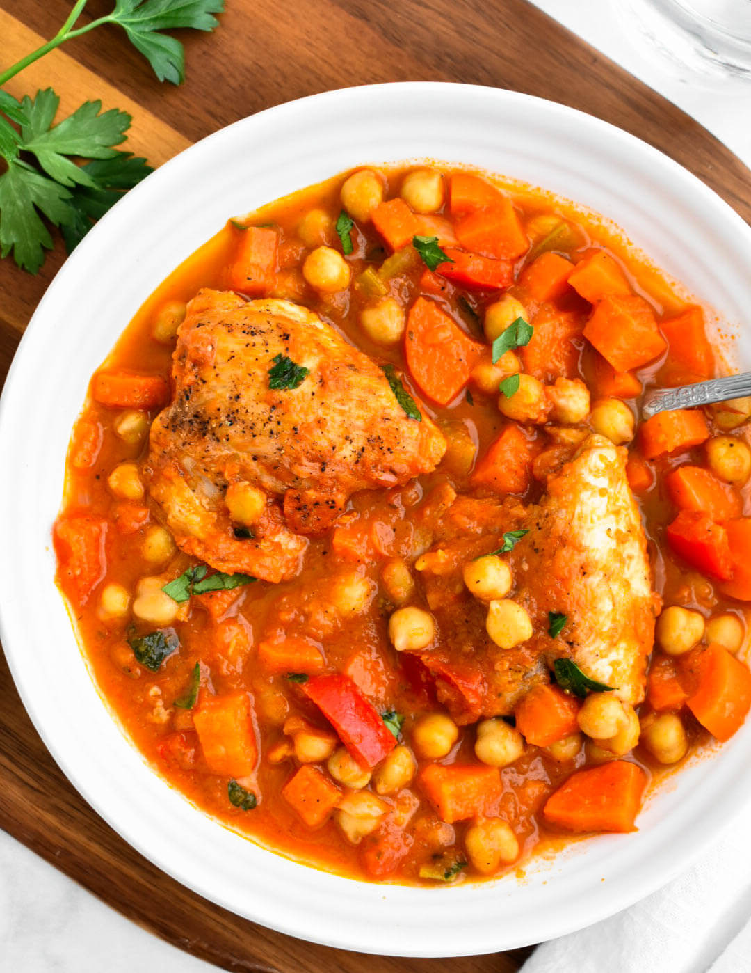 Closeup of a bowl of Greek chicken and chickpea stew.