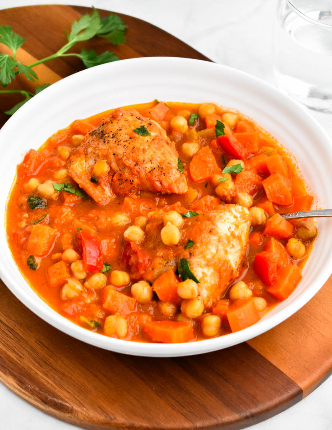 Closeup of a bowl of Greek chicken and chickpea stew.